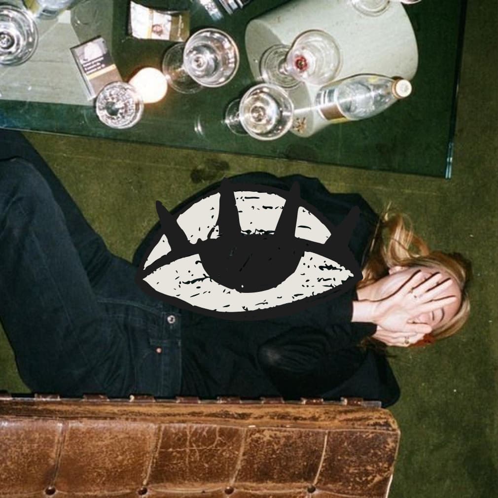 Casa Culta eye mark over a photograph of a person resting on a green floor